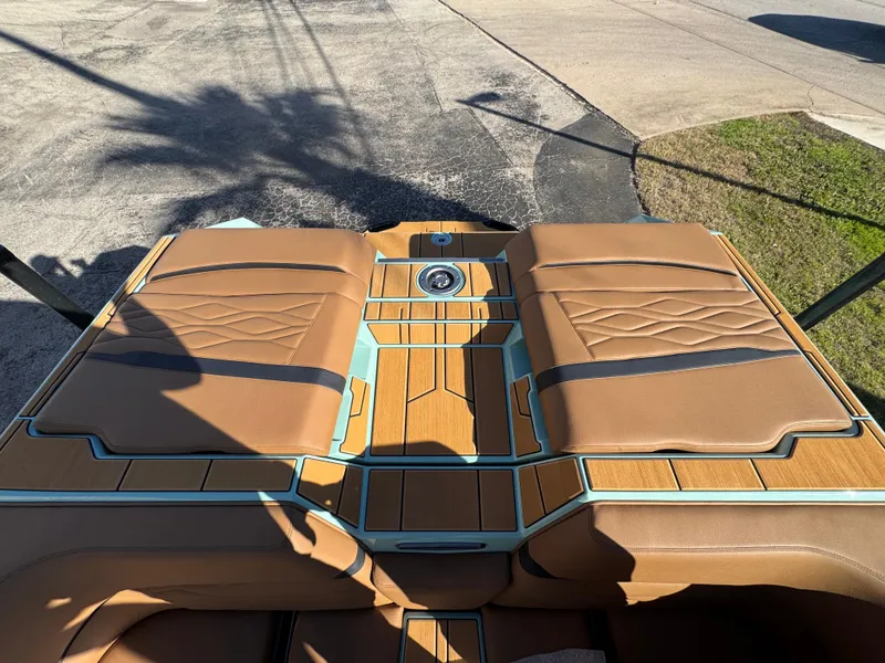 Slide: The Image of 2025 Supra SL 450 boat interior with tan leather seats and wood accents. - 20