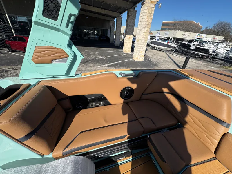 Slide: The Image of 2025 Supra SL 450 boat interior with tan leather seats and teal accents. - 30