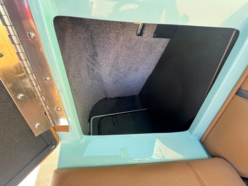 Slide: The Image of Interior storage compartment of 2025 Supra SL 450, featuring a sleek design and brown upholstery. - 31