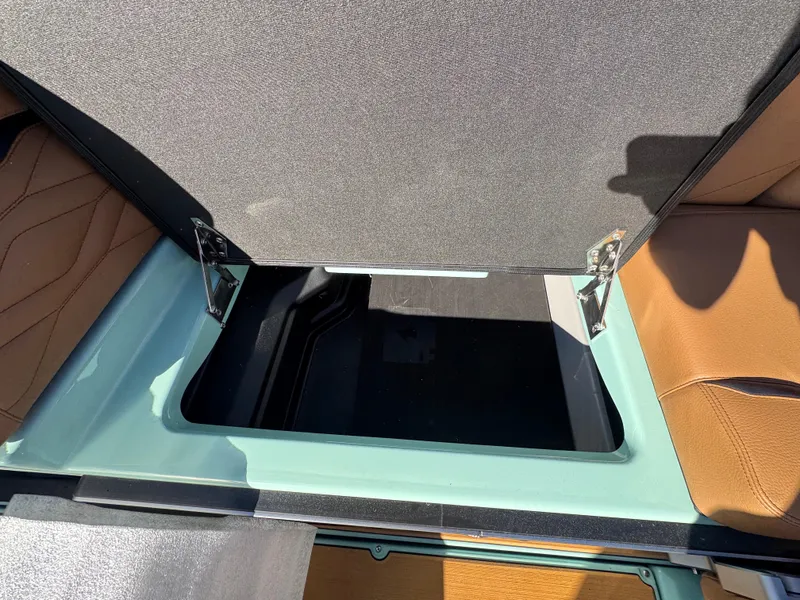 Slide: The Image of 2025 Supra SL 450 interior storage compartment with open lid, showcasing spacious design. - 32