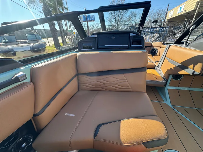 Slide: The Image of 2025 Supra SL 450 boat interior with tan leather seating and modern dashboard. - 34