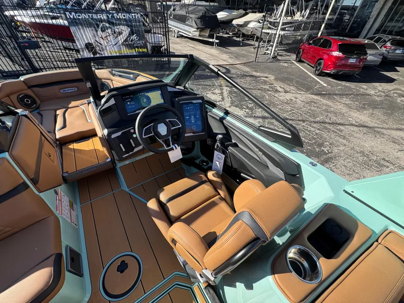 Slide: The Image of 2025 Supra SL 450 boat interior with modern dashboard and tan seating. - 36