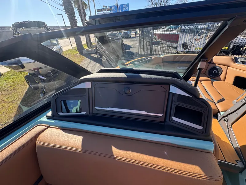 Slide: The Image of 2025 Supra SL 450 boat interior with modern dashboard and tan seating. - 45