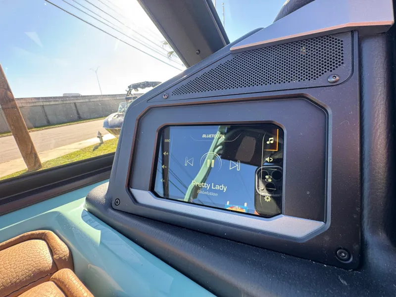 Slide: The Image of 2025 Supra SL 450 dashboard with touchscreen display showing music controls. - 47