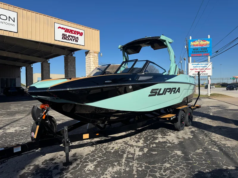 Slide: The Image of 2025 Supra SL 450 boat on trailer at dealership, showcasing sleek design and modern features. - 5