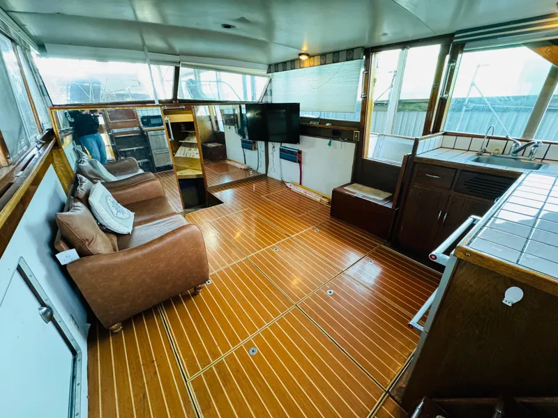 Slide: The Image of Interior of a 1965 Chris-Craft 38 Constellation with wooden flooring and comfortable seating. - 11