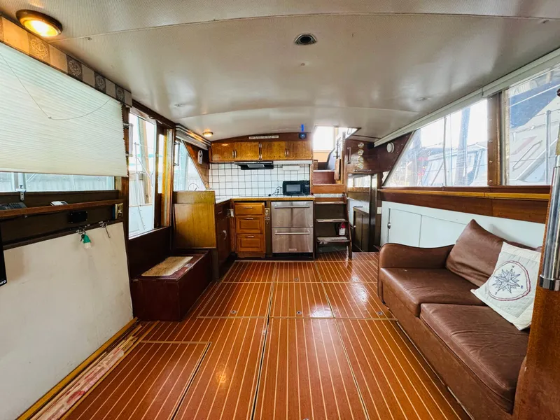 Slide: The Image of Interior of a 1965 Chris-Craft 38 Constellation boat with wood flooring and cozy seating. - 12