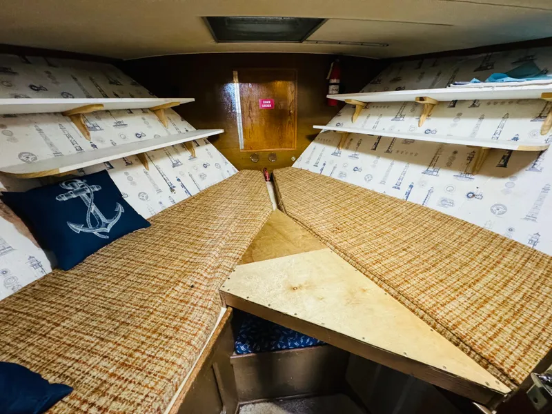Slide: The Image of 1965 Chris-Craft 38 Constellation cabin interior with nautical decor and cozy sleeping area. - 21