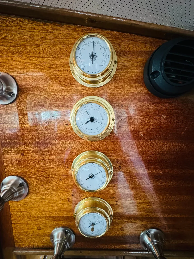 Slide: The Image of Vintage brass gauges on 1965 Chris-Craft 38 Constellation wooden dashboard. - 22