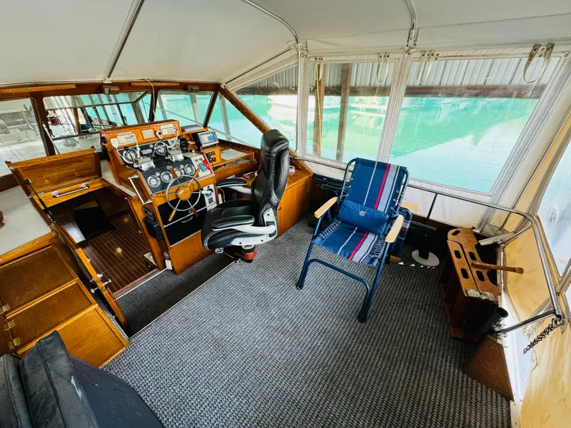 Slide: The Image of 1965 Chris-Craft 38 Constellation helm with vintage controls and seating, docked in a marina. - 24