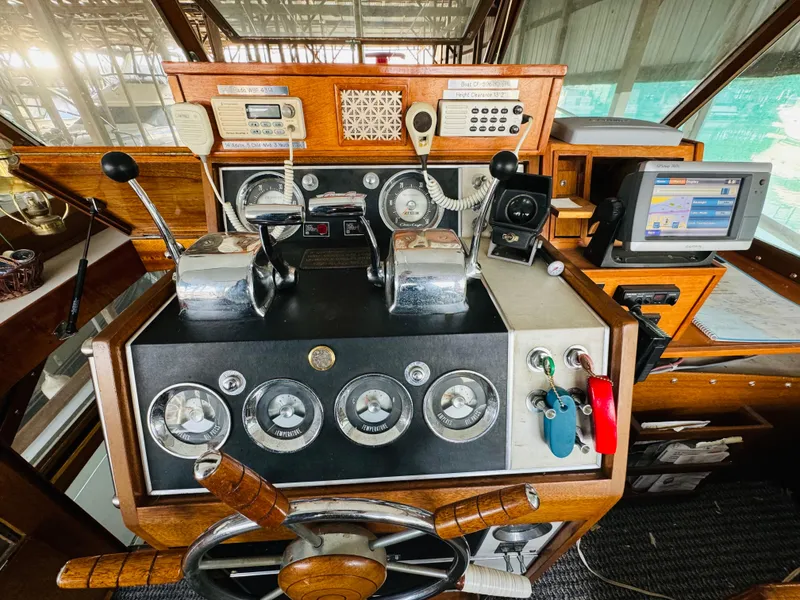 Slide: The Image of 1965 Chris-Craft 38 Constellation helm with vintage controls and modern navigation equipment. - 27
