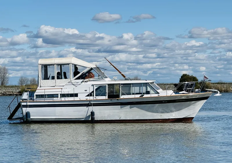 Slide: The Image of 1965 Chris-Craft 38 Constellation boat on calm water under a cloudy sky. - 3