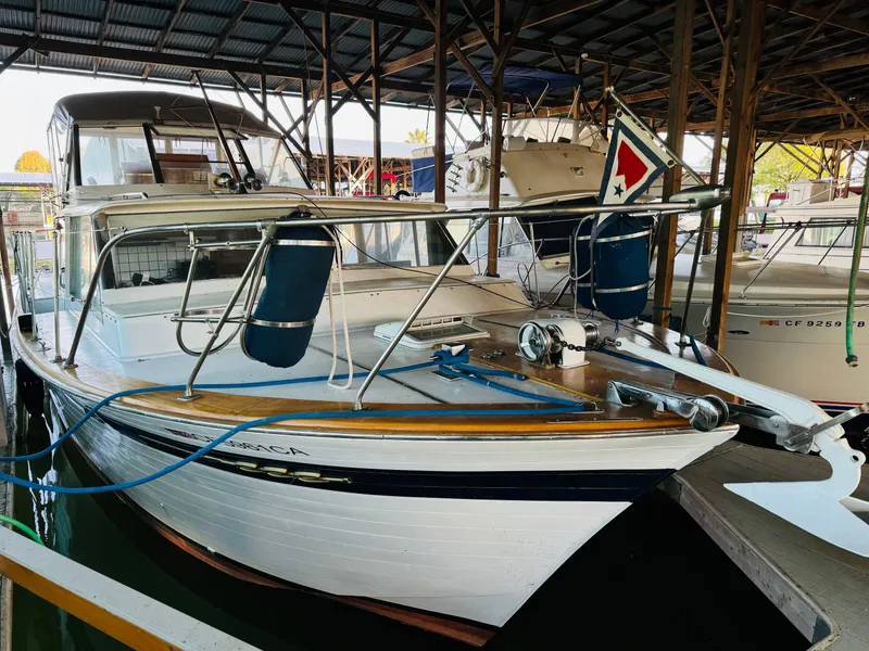 Slide: The Image of 1965 Chris-Craft 38 Constellation boat docked in a covered marina. - 5