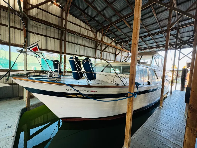 Slide: The Image of 1965 Chris-Craft 38 Constellation docked in a covered marina. - 6