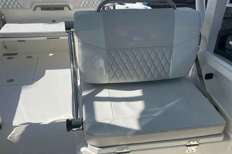 Slide: The Image of 2024 World Cat 260 DC-X boat interior with luxurious seating and diamond-pattern upholstery. - 11