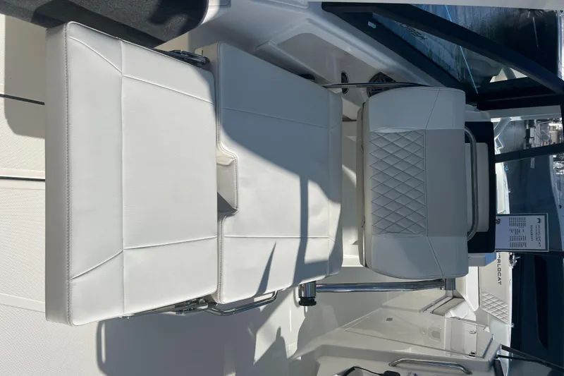 Slide: The Image of 2024 World Cat 260 DC-X boat interior with white cushioned seating and sleek design. - 12