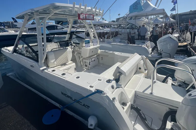 Slide: The Image of 2024 World Cat 260 DC-X boat displayed at a marina, showcasing sleek design and spacious seating. - 3