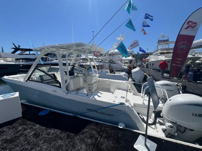 Slide: The Image of 2024 World Cat 260 DC-X boat displayed at a marina event under clear blue skies. - 4