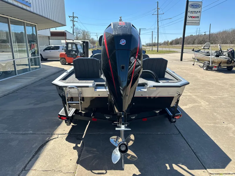 Slide: The Image of 2025 Vexus AVX 1895S boat, rear view, parked outdoors with motor and propeller visible. - 3