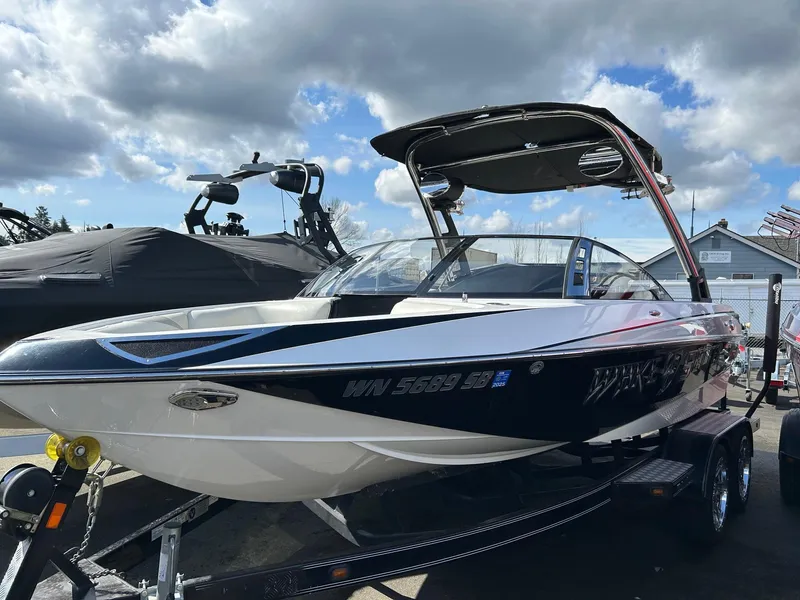 The Image of 2013 Malibu Wakesetter 20 VTX boat on trailer under cloudy sky. - 0