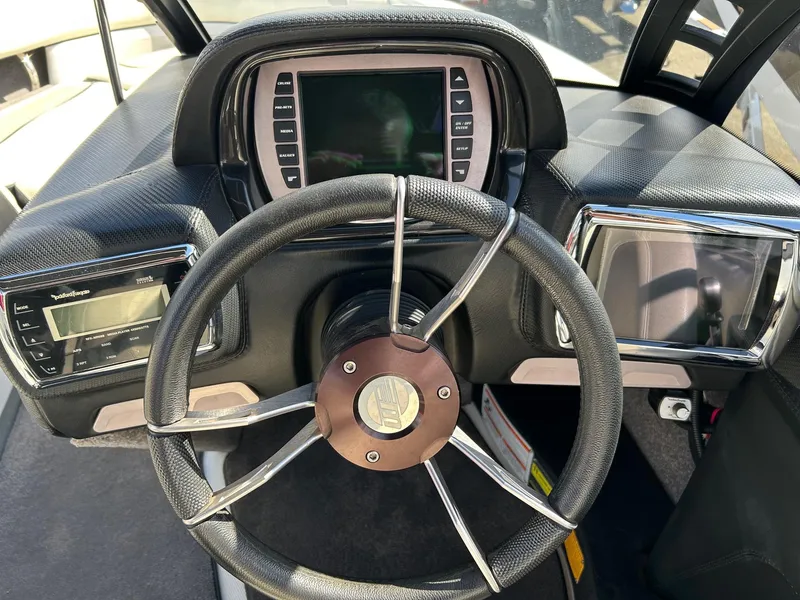 Slide: The Image of 2013 Malibu Wakesetter 20 VTX dashboard with steering wheel and digital displays. - 4