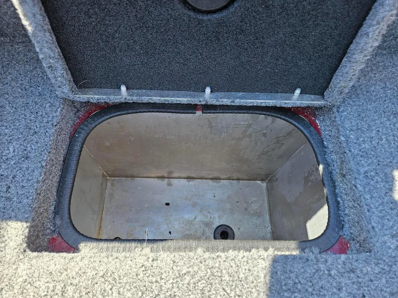 Slide: The Image of Open storage compartment in 2022 Tracker Pro Team 195 TXW Tournament Edition boat. - 14