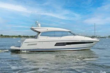 Slide: The Image of 2019 Prestige 460S yacht cruising on a calm sea under a clear blue sky. - 11