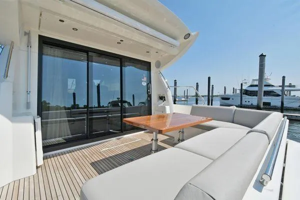 Slide: The Image of Luxury yacht deck with seating and table, Prestige 460S, 2019 model, docked at marina. - 13