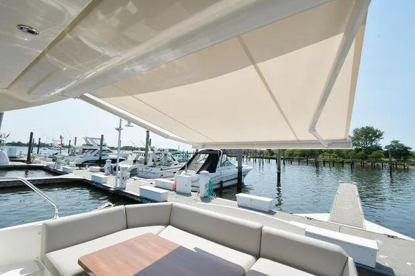Slide: The Image of Luxurious 2019 Prestige 460S yacht with spacious deck and awning at marina. - 14