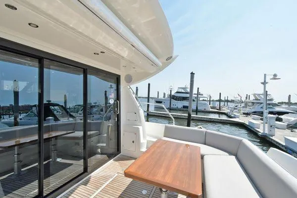 Slide: The Image of 2019 Prestige 460S yacht with elegant deck seating and marina view. - 16