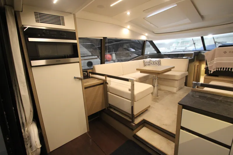 Slide: The Image of Luxurious interior of a 2019 Prestige 460S yacht with modern seating and kitchen area. - 27