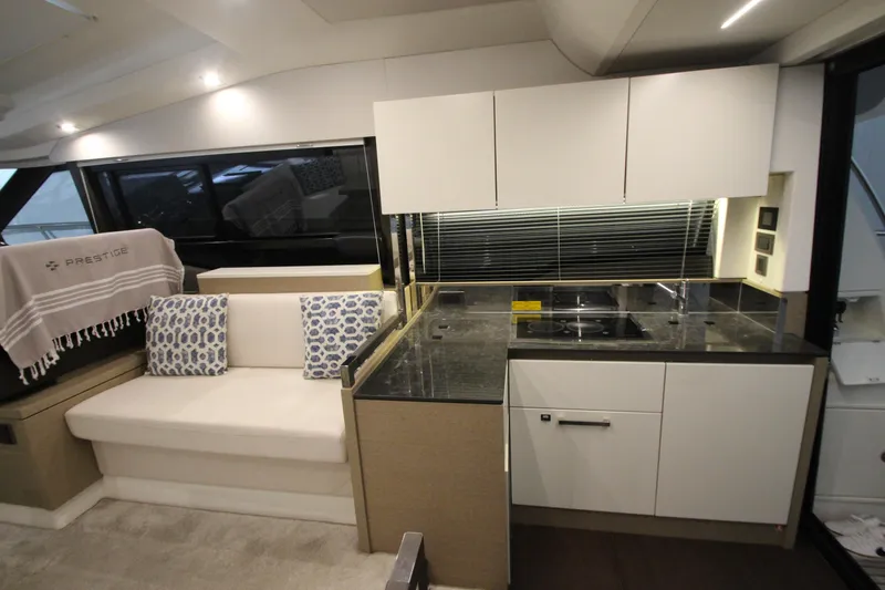 Slide: The Image of Luxurious interior of 2019 Prestige 460S yacht with modern kitchen and seating area. - 30