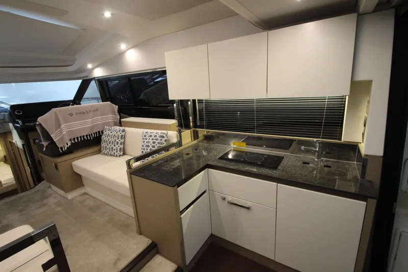 Slide: The Image of Luxurious interior of 2019 Prestige 460S yacht with modern kitchen and seating area. - 31