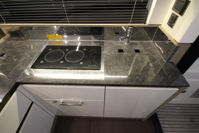 Slide: The Image of Modern kitchen in 2019 Prestige 460S yacht with sleek countertops and stovetop. - 32