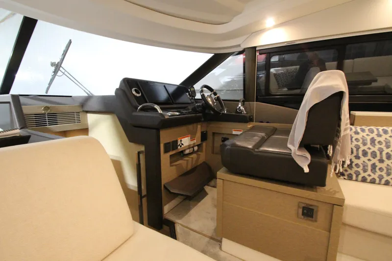 Slide: The Image of Interior of a 2019 Prestige 460S yacht, featuring a modern helm and seating area. - 36