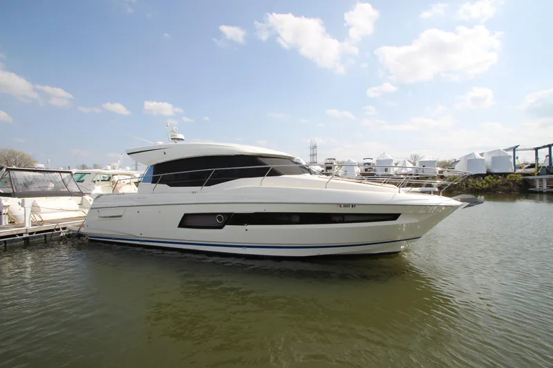 Slide: The Image of 2019 Prestige 460S yacht docked in a marina under a clear blue sky. - 4