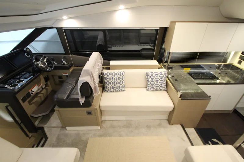 Slide: The Image of Luxurious interior of 2019 Prestige 460S yacht with modern seating and kitchen area. - 42