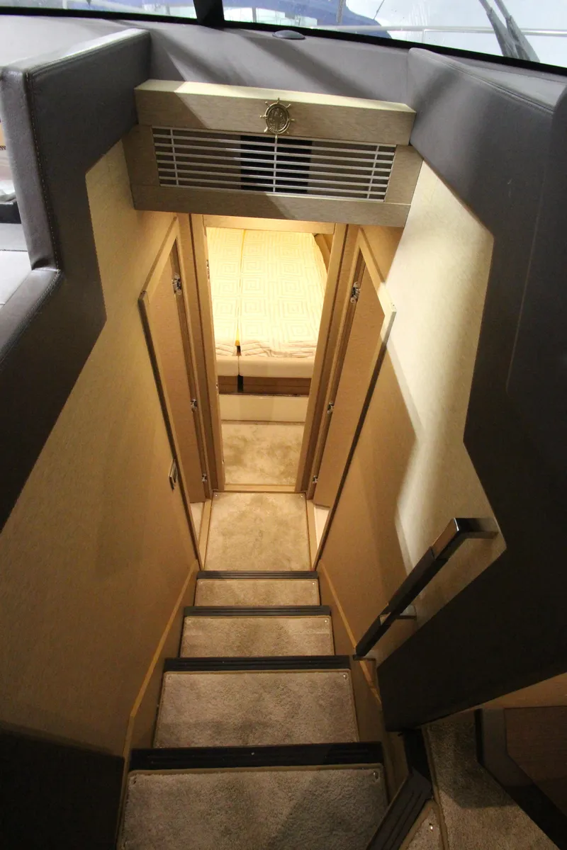 Slide: The Image of Staircase inside 2019 Prestige 460S yacht, leading to cabin area with modern design. - 49