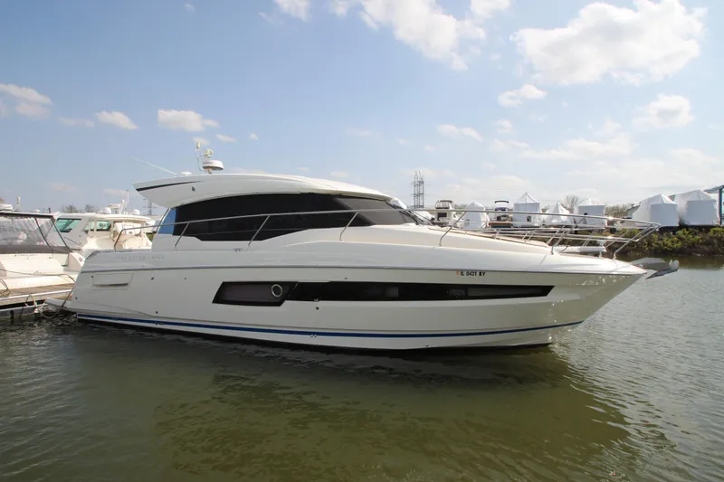 Slide: The Image of 2019 Prestige 460S yacht docked in a marina under a clear blue sky. - 5
