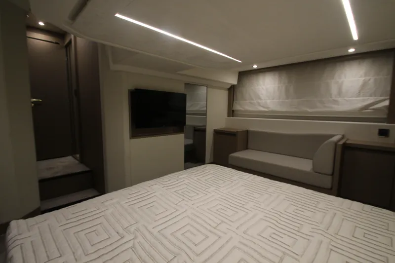 Slide: The Image of Luxurious interior of a 2019 Prestige 460S yacht, featuring a cozy bedroom and modern design. - 53