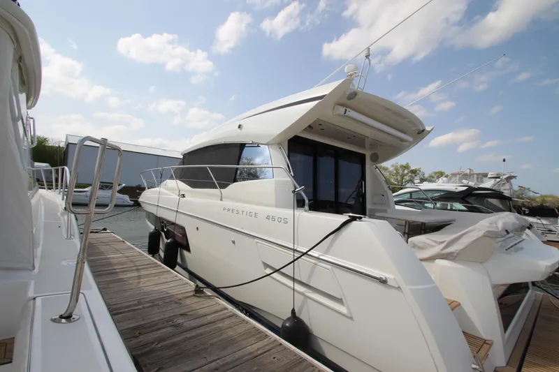 Slide: The Image of 2019 Prestige 460S yacht docked under a clear blue sky. - 6