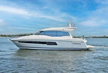 Slide: The Image of 2019 Prestige 460S yacht cruising on calm waters under a clear blue sky. - 8