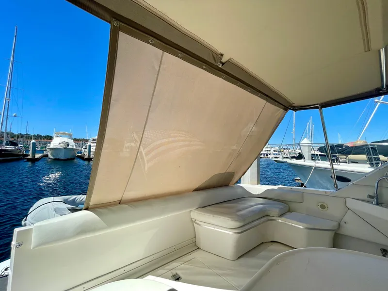 Slide: The Image of 1999 Sea Ray 500 Sundancer yacht interior with sunshade, docked at marina. - 37
