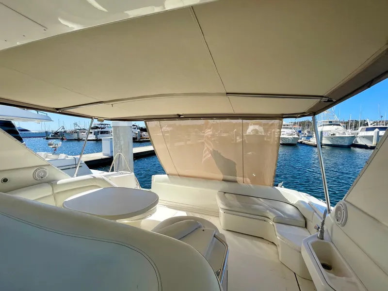Slide: The Image of 1999 Sea Ray 500 Sundancer yacht interior with seating and table, docked at marina. - 39
