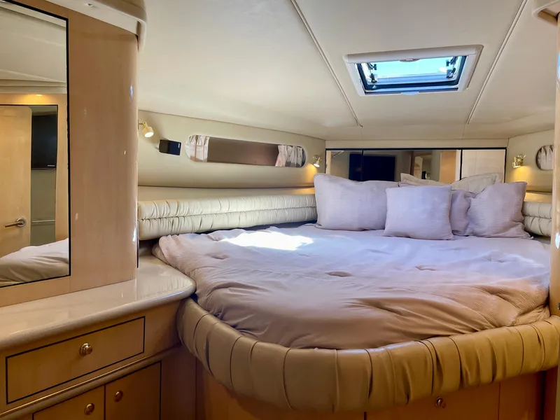 Slide: The Image of Luxurious cabin interior of 1999 Sea Ray 500 Sundancer yacht with plush bedding. - 4