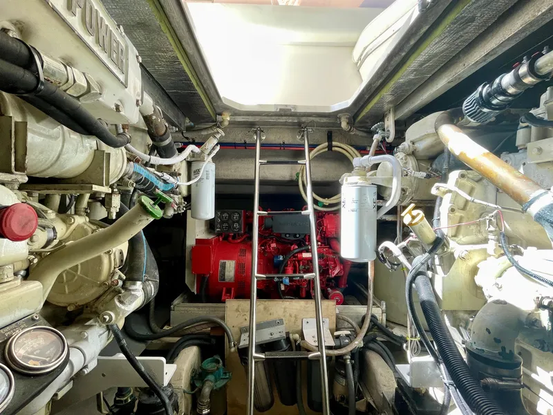 Slide: The Image of Engine room of a 1999 Sea Ray 500 Sundancer, showcasing mechanical components and systems. - 42