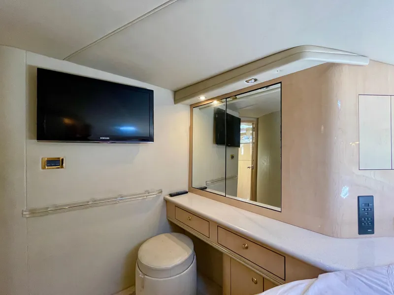 Slide: The Image of Interior of 1999 Sea Ray 500 Sundancer with TV, vanity, and storage. - 6