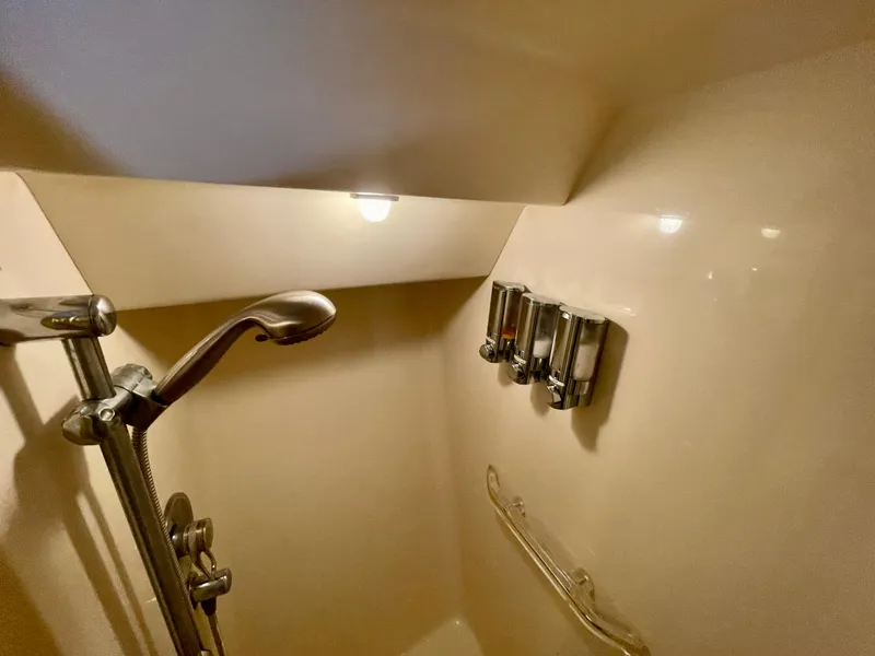 Slide: The Image of Shower area in 1999 Sea Ray 500 Sundancer yacht with modern fixtures and lighting. - 8