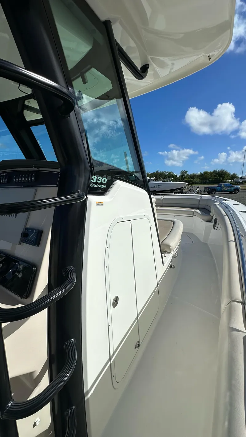Slide: The Image of 2022 Boston Whaler 330 Outrage boat, sleek design, sunny day, blue sky, luxury features. - 13