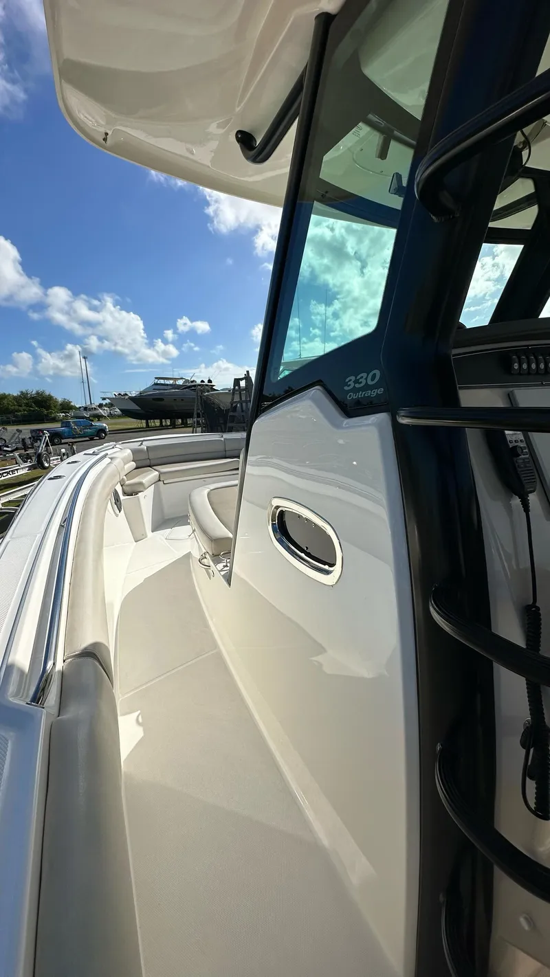 Slide: The Image of 2022 Boston Whaler 330 Outrage boat, sleek design, sunny day, clear blue sky. - 2